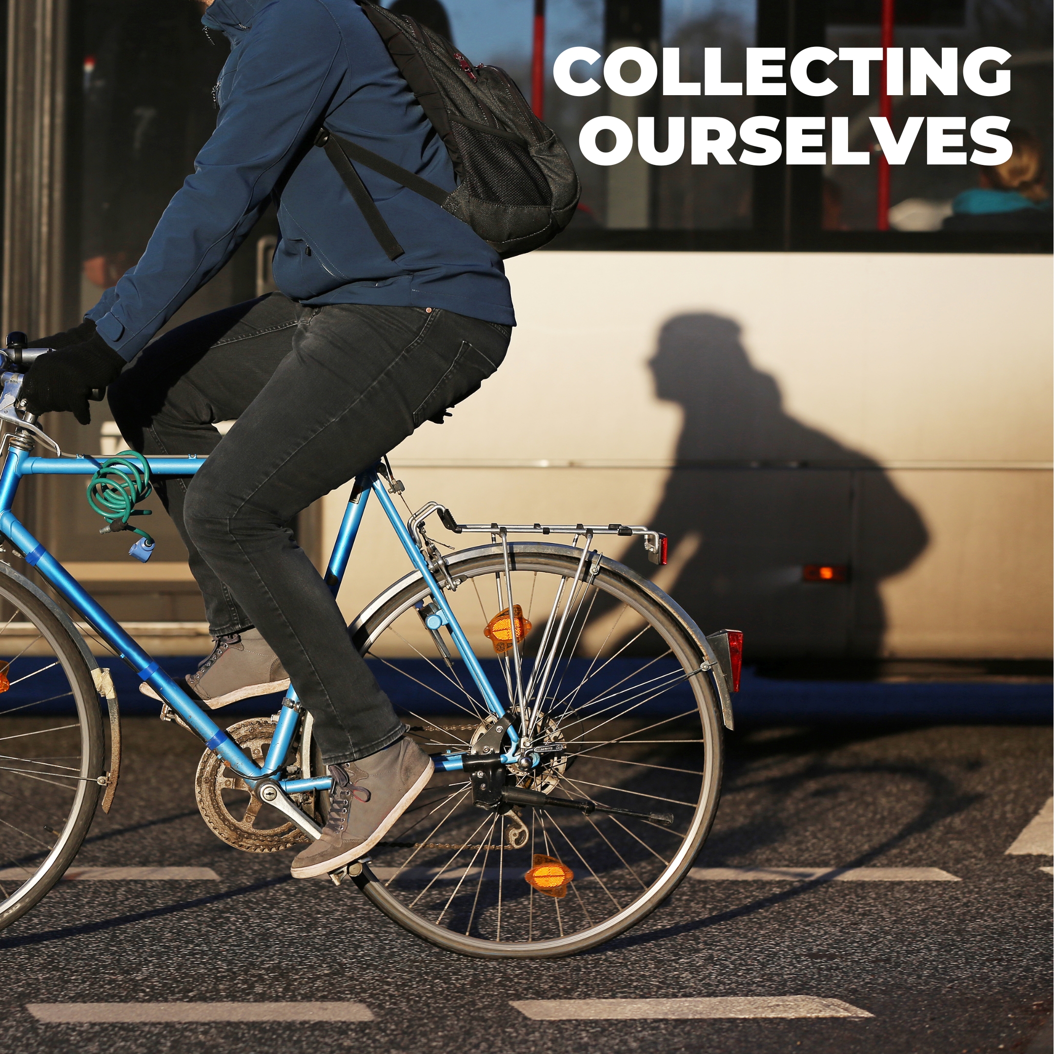 person riding a bicycle next to a bus