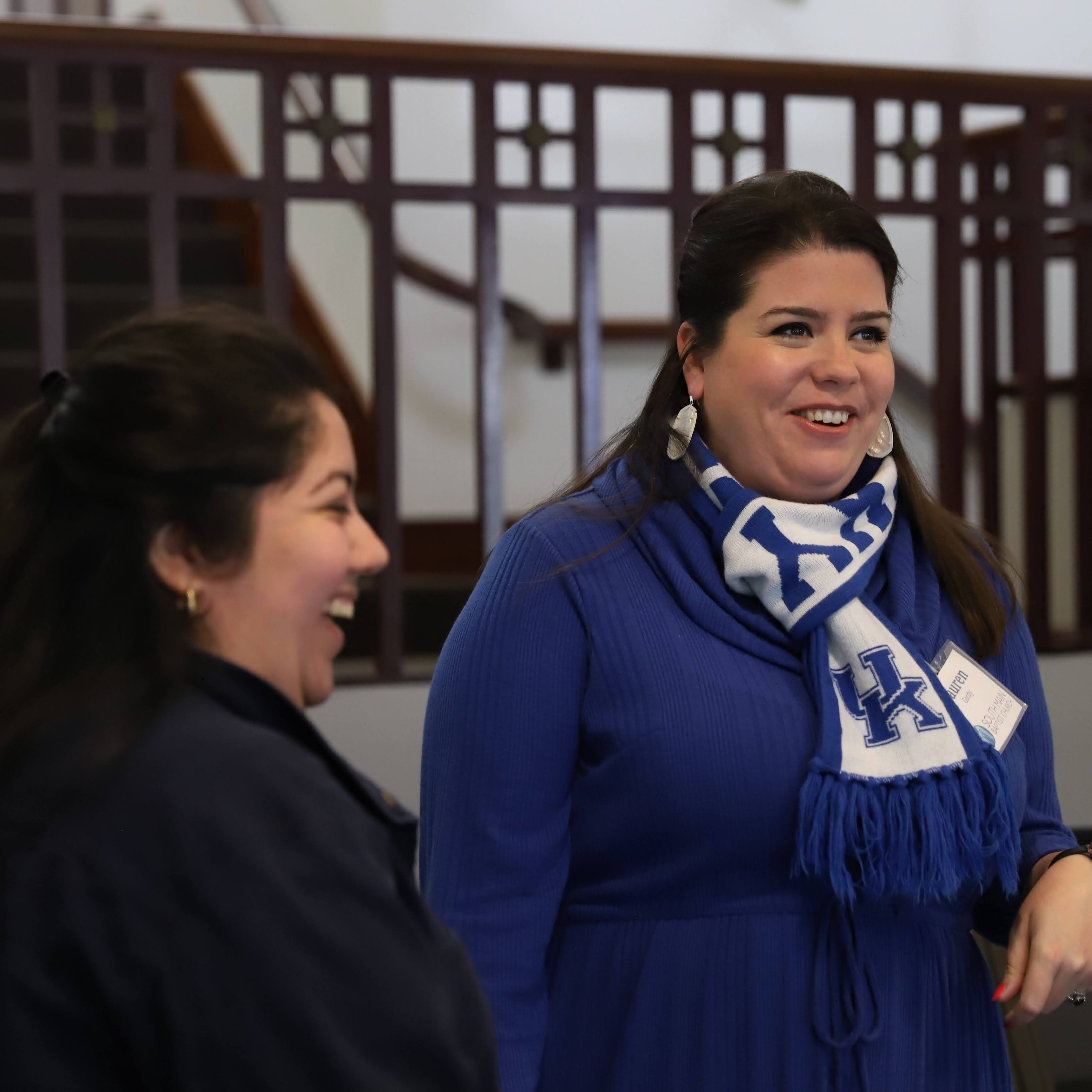 two women talking and laughing