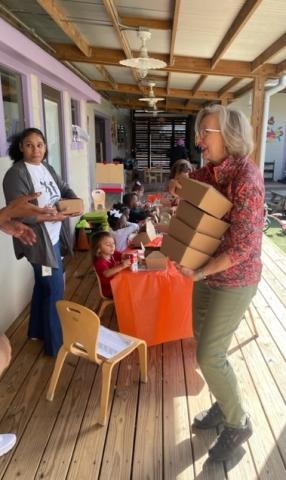 woman carrying boxed lunches