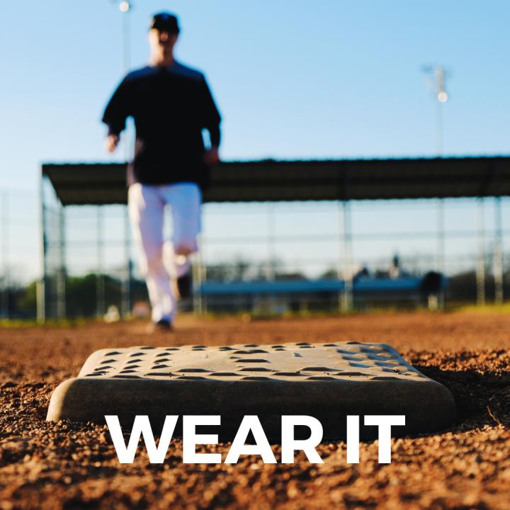 Baseball player running to a base with the words Wear It