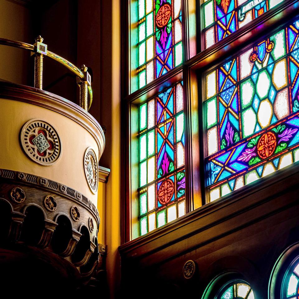 Interior of stained glass windows next to balcony