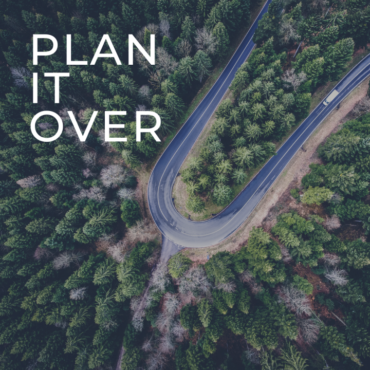 Overhead view of switchback curve in a highway through a forest with the text Plan It Over